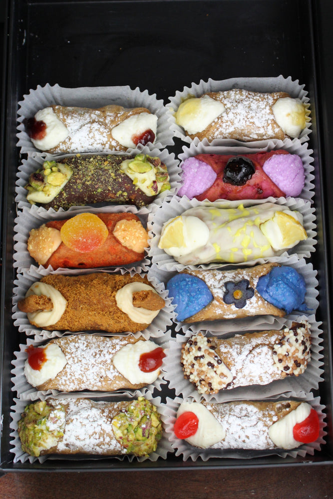 Presenting our SetBox of 12 Small Cannoli which makes a delightful gift for loved ones or a wonderful addition to your dessert spread.  Included in the SetBox of 12 Small Cannoli are: Left Row (top to bottom)~Signature Fieldberry Jelly, Chocolate Pistachio, Peach Fuzz, The Biscoff, Signature Rosehip Jelly, Traditional Pistachio, Right row~Signature Pineapple Jelly, Cherries Jubilee, Lemon Truffle, Blue Matcha, Traditional Chocolate, and Traditional Cherry.