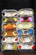 Presenting our SetBox of 12 Small Cannoli which makes a delightful gift for loved ones or a wonderful addition to your dessert spread.  Included in the SetBox of 12 Small Cannoli are: Left Row (top to bottom)~Signature Fieldberry Jelly, Chocolate Pistachio, Peach Fuzz, The Biscoff, Signature Rosehip Jelly, Traditional Pistachio, Right row~Signature Pineapple Jelly, Cherries Jubilee, Lemon Truffle, Blue Matcha, Traditional Chocolate, and Traditional Cherry.