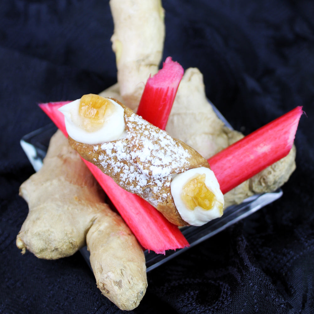 If you love the zing of ginger and the tangy, sweetness of rhubarb... this Signature Jelly Cannoli is for you!  A brand new addition to our Jelly Collection this month is straight from the caldrons in Chef Maria's kitchen!  The deep flavours of ginger/rhubarb jelly are piped into the centre of our creamy, smooth ricotta and encased in our crispy, crunchy pastry shell then delicately sprinkled with powdered sugar!    *AVAILABLE WITH DAIRY-FREE CREAM FILLING
