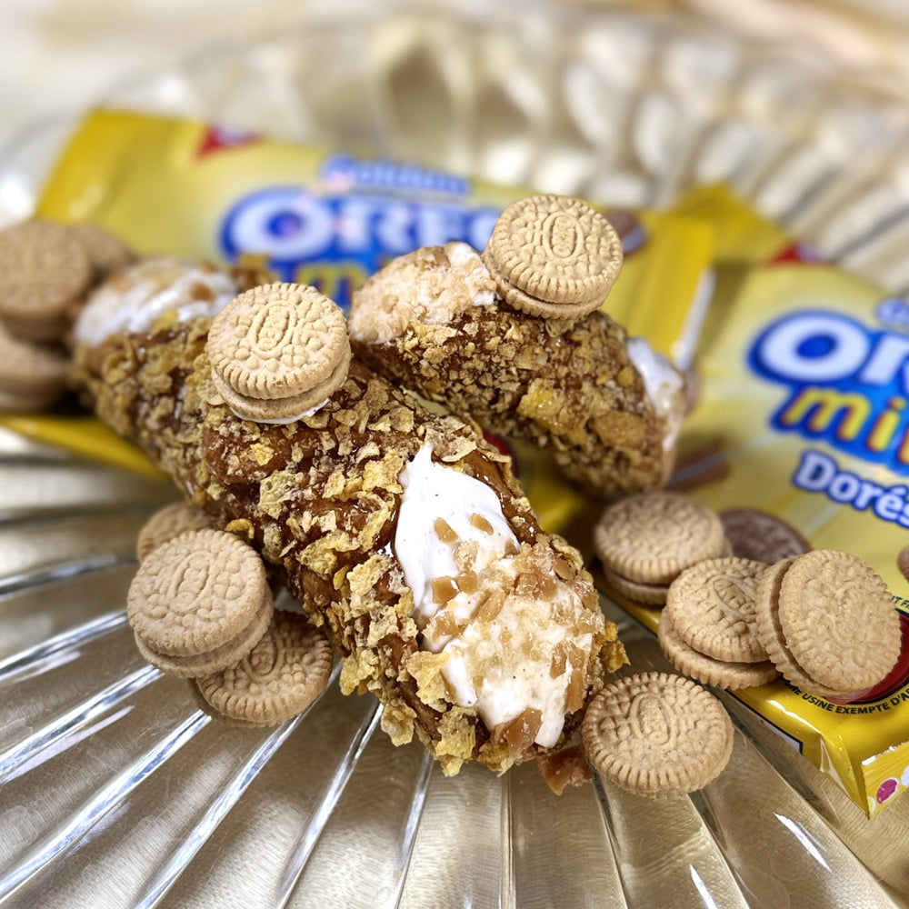 Say hello to the Golden Oreo Cannolo — the autumn sunshine of the dessert world! This golden beauty starts with a crispy, crunchy cannolo shell and has swirls of fluffy vanilla filling, bringing all the fun of a cookie jar party to every single bite. It’s sweet, crunchy, and a little bit cheeky — like a dessert that can’t stop smiling. Take one bite, and you’ll swear it’s made of pure happiness (with a dash of sparkle for good measure).