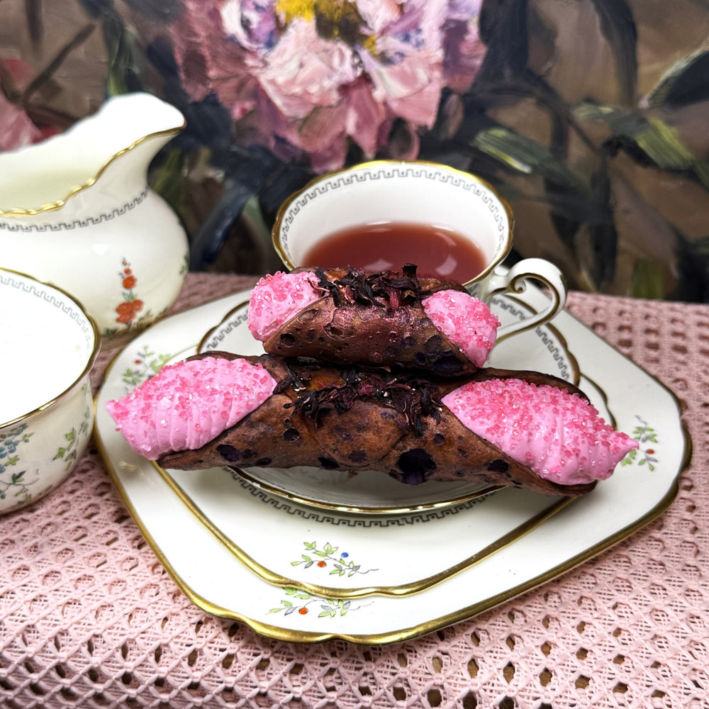 A Blooming Delight for Mom!!&nbsp; Celebrate the incredible woman in your life with a truly unique and elegant treat - our&nbsp;Hibiscus-Flavoured Cannoli, crafted especially for Mother’s Day. Delicate hibiscus-infused ricotta filling&nbsp;offers a subtle floral tang that’s refreshing and aromatic, filling our crispy, crunchy pastry shells. This beautiful dessert combines the timeless charm of the classic Italian cannoli with the vibrant, floral notes of hibiscus, creating a sweet and refreshing tribute.