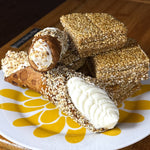 Indulge in the perfect harmony of crunchy, creamy, and sweet with our&nbsp;Honeyed Sesame Cannoli. This exquisite dessert takes the traditional Sicilian cannoli to new heights by rolling the crisp pastry shell in toasted sesame seeds, with a velvety, smooth ricotta infused with a luscious field honey that adds a subtle, aromatic sweetness.

Treat yourself or impress your guests with this sophisticated, mouthwatering dessert!