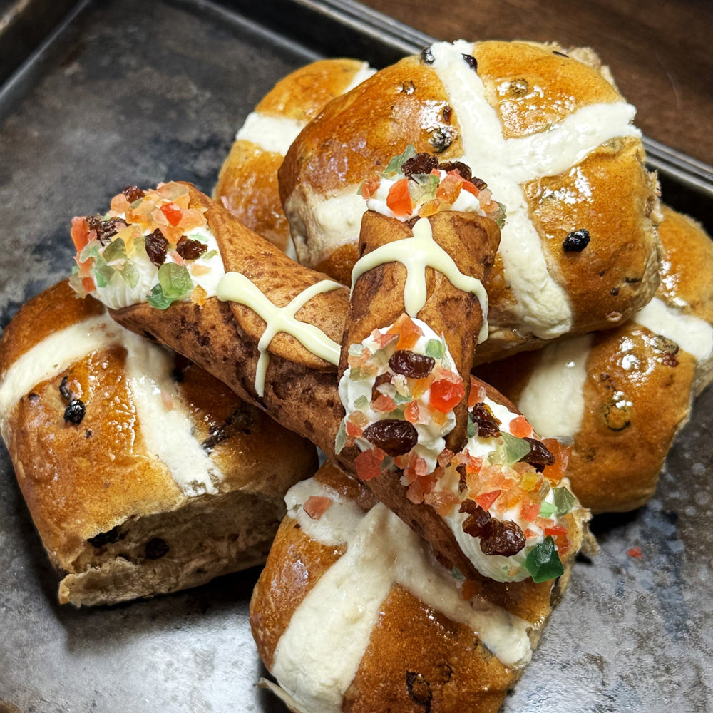 A crisp, golden-brown shell is marked with a white chocolate cross and our creamy, smooth ricotta is infused with aromatic cinnamon, nutmeg, and allspice!&nbsp; The finishing touch?&nbsp; The ends are&nbsp;dotted with candied fruit and raisins!&nbsp; Perfect for Easter or any time you crave a fusion of comforting flavours, this Hot Cross Bun Cannoli is the ultimate treat for those seeking something unique and irresistible.