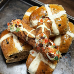 A crisp, golden-brown shell is marked with a white chocolate cross and our creamy, smooth ricotta is infused with aromatic cinnamon, nutmeg, and allspice!&nbsp; The finishing touch?&nbsp; The ends are&nbsp;dotted with candied fruit and raisins!&nbsp; Perfect for Easter or any time you crave a fusion of comforting flavours, this Hot Cross Bun Cannoli is the ultimate treat for those seeking something unique and irresistible.