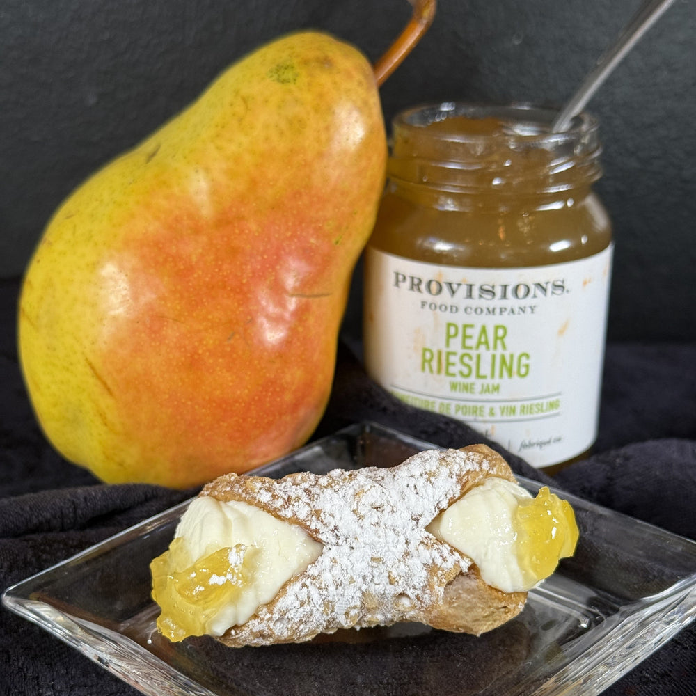 Welcome the sparkle of Christmas with our Signature Pear Riesling Jelly Cannoli, a sophisticated twist on a beloved classic. Crisp, golden cannoli shells cradle a silky ricotta filling kissed with vanilla bean, encasing a heart Pear Riesling jelly that glows like winter sunlight. Each bite balances the gentle sweetness of ripe pears with the bright, floral notes of wine for a taste that feels both comforting and refined.
