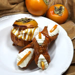 This luscious ripe persimmon berry, fondly called "kaki," is a Sicilian treasure! We've reduced the fruit and infused it into our creamy, smooth ricotta then piped the blend into our crispy, crunchy orange pastry shell.&nbsp; A drizzle of caramel atop and a fresh slice of persimmon on the ends adds to the sweet and tangy flavour! &nbsp;Treat yourself to a flavour journey with this one-of-a-kind combination!