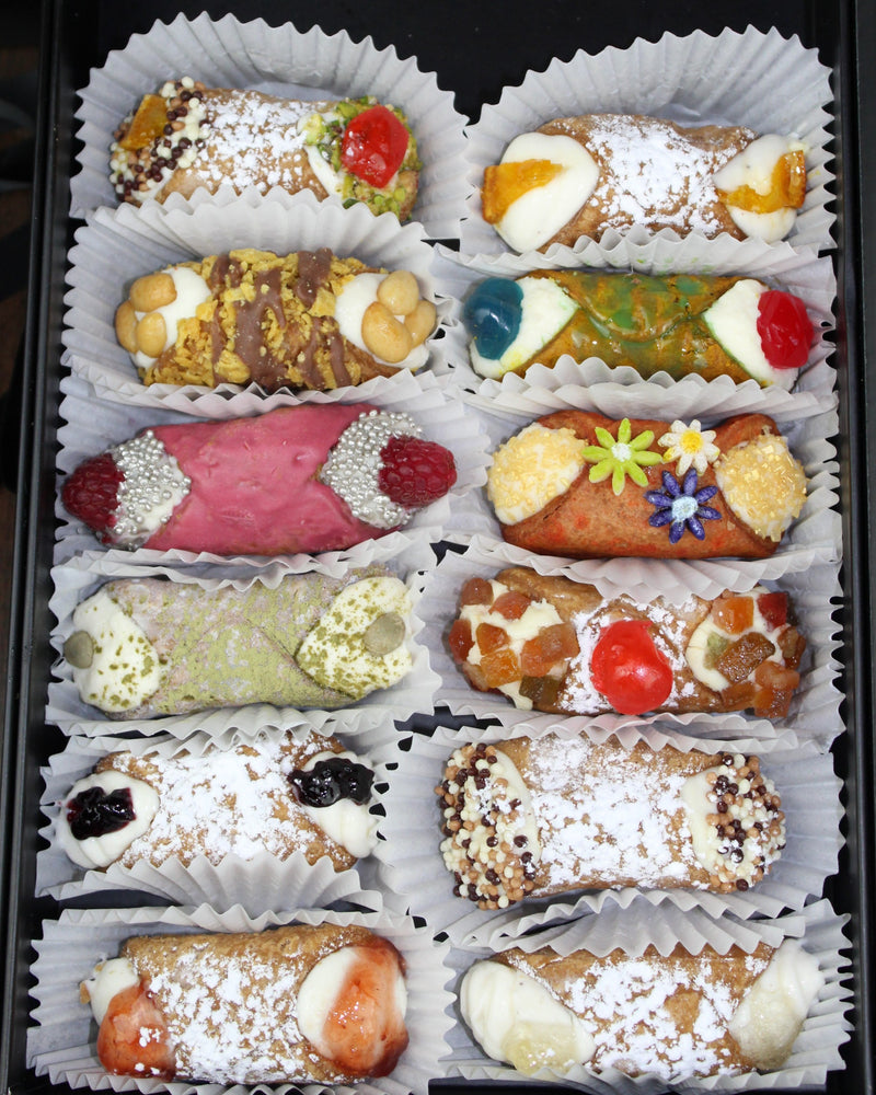 Treat yourself to the taste of luxury defined by pure ingredients, master craftsmanship, and artistic license!  Included in this month's SetBox of 6 Small Gourmet Cannoli are:  Left row (top to bottom):  The Everything Cannoli, Fruckies Cannoli, The Love Potion, The White Coffee, Signature Grape Jelly, Signature Strawberry Kiwi,  Right row (top to bottom):  Traditional Orange, The Gusher, The Bouquet, Frutta Scorza, Traditional Chocolate, and Signature Rose Jelly.