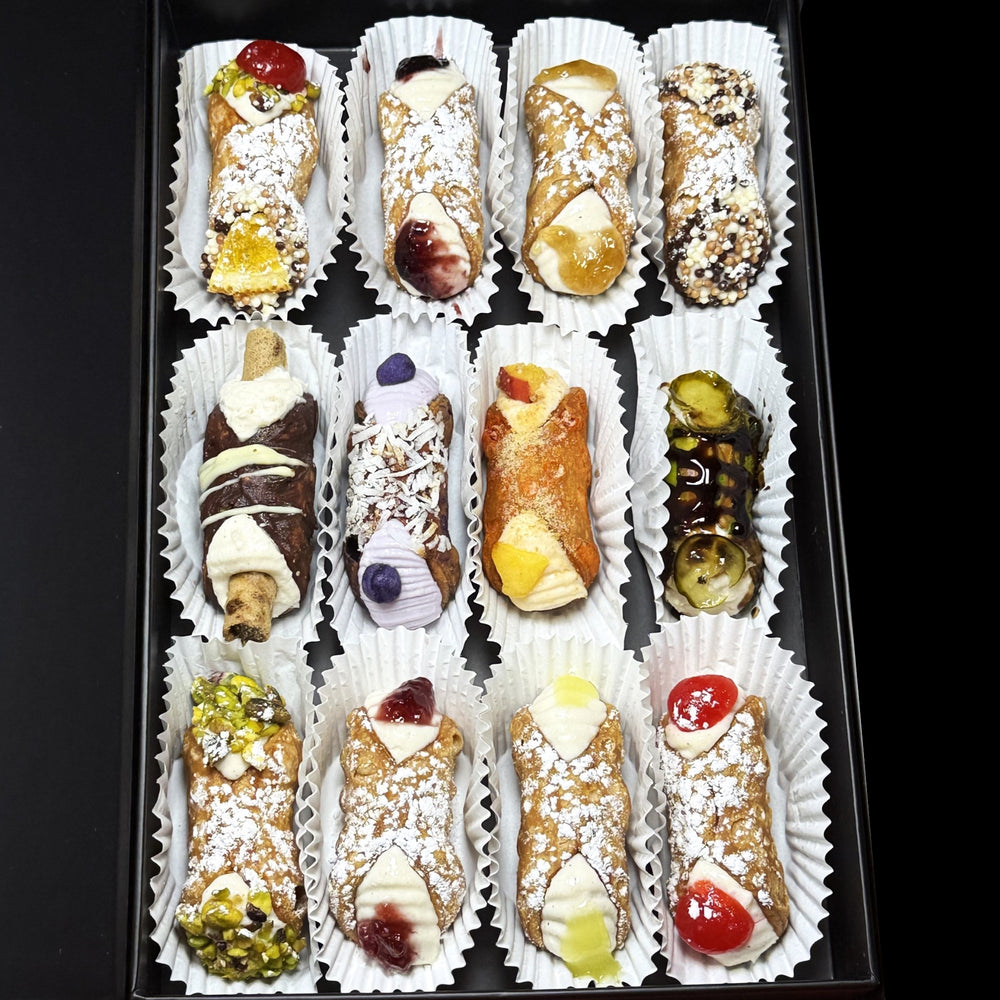 Luxuriate in the ultimate Italian treat with our SetBox of 12 Assorted Gourmet Cannoli. Top Row (left to right):&nbsp; The Everything, Blueberry Jelly, Rhubarb/Ginger Jelly, Traditional Chocolate

Middle Row (left to right):&nbsp; The Wafer, The Coconut Ube, The Peach Cobbler, The Sugar'd Pickle

Bottom Row (left to right):&nbsp; Traditional Pistachio, Raspberry Jelly, Lemon Jelly, and Traditional Cherry.