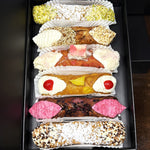 Included in the SetBox of 6 Large Cannoli are:


Top to bottom:&nbsp; Traditional Pistachio, The Honeyed Sesame, The Pink Angel Hair Chocolate, The Upside-Down Pineapple, The Hibiscus, and Traditional Chocolate.


Whether as a special treat for yourself or a delightful gift, this SetBox offers an authentic taste of Italy that will satisfy the Foodie in you!