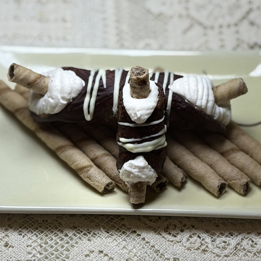 Experience pure decadence with our Chocolate-Covered Wafer Cannoli, a playful twist on a classic Italian treat. Each hand-rolled cannolo shell is lavishly coated in silky chocolate, creating a crisp, luxurious exterior. Inside, you'll discover a rich, velvety ricotta cream filling—smooth, subtly sweet, and irresistibly indulgent. At the heart of this confection is a hidden surprise: a crunchy chocolate wafer, adding a delightful layer of texture and bold cocoa flavour. 
