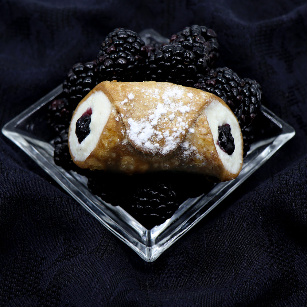 Did you ever think of such a thing?  Well, we did!  We combined our fresh, smooth ricotta filling with a dollop of blackberry jelly in the centre of our crispy, crunchy pastry cannoli shell making this one of our favourite Signature Jelly Cannoli.  Come and take a bite.  Every bite counts!!
*AVAILABLE WITH DAIRY-FREE CREAM FILLING!
