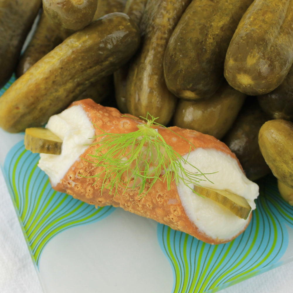 Here at Cannoli Crunch, we love our pickles!  It's a grab-and-go snack we always have in the fridge!  Now, we have created this savoury treat for you!  Our creamy, smooth ricotta is blended with our secret seasonings and then piped into our crispy, crunchy shell and finished with slivers of pickles on the ends and dill on top!  It's a cheese and pickle combo better than anything you've tried!  