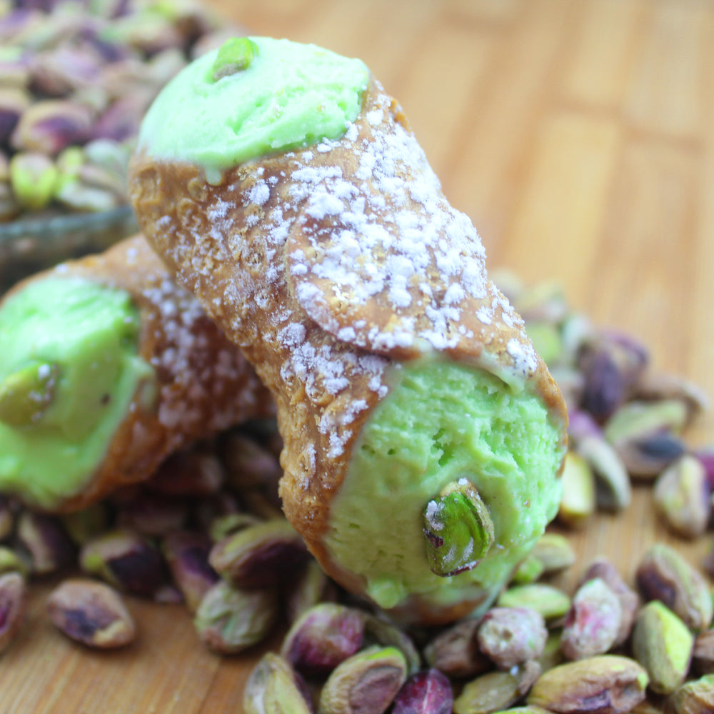 What a treat!  Here we have a crispy, crunchy deep fried cannoli shell filled with the delectable flavour of pistachio gelato. The cool, mild taste of roasted pistachios in the creamy form of gelato plays a fun whimsical dance on your palate! Topping our refreshment is a dusting of powdered sugar and roasted nuts on the end!    www.cannolicrunch.ca