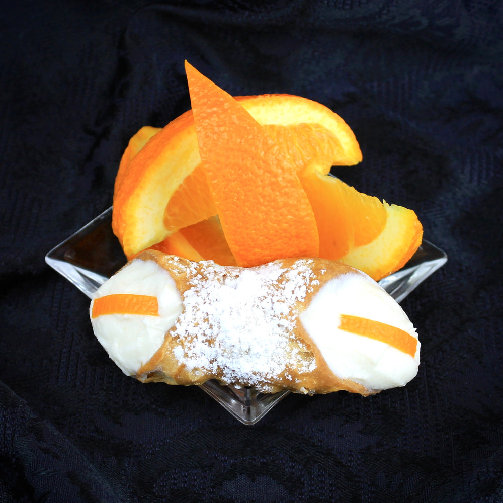 As far as time can tell, oranges have graced the hills of Sicily. Cannoli has been a favorite dessert for centuries as well.  Staying close to tradition we have added an Orange Cannoli to our lineup. The smooth, creamy ricotta, the crispy, crunchy pastry shell, and then finishing it with candied orange pieces couldn't get any better.